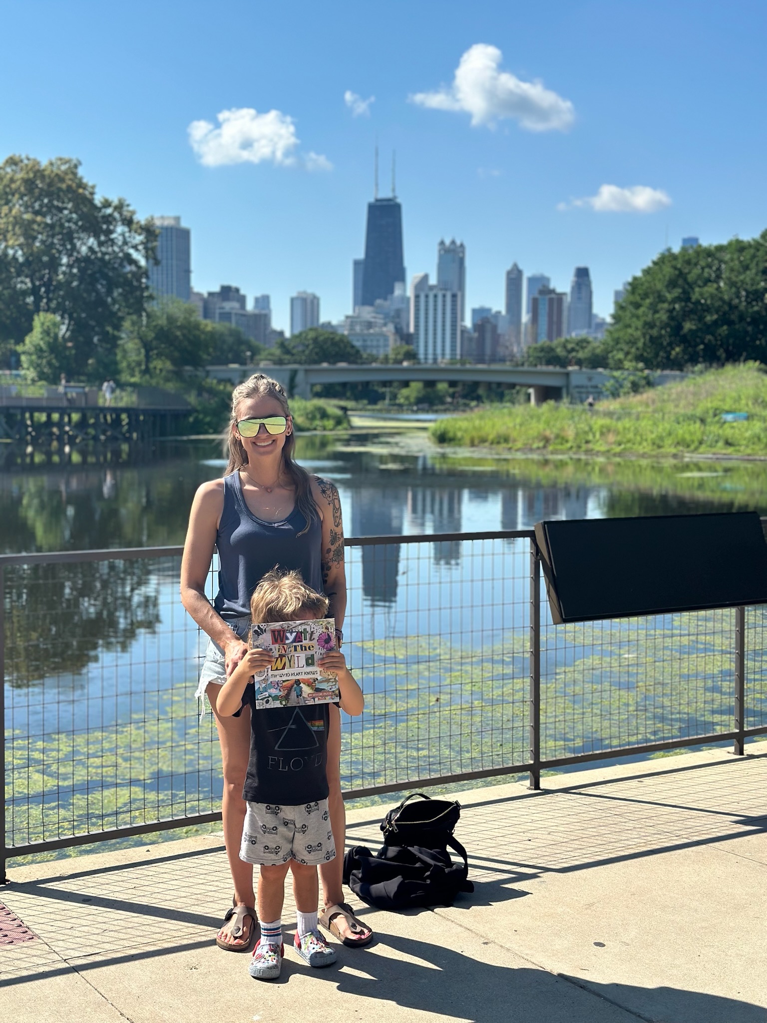 Adeline and Wyatt at Lincoln Park Zoo in Chicago holding the book Wyatt in the wyld