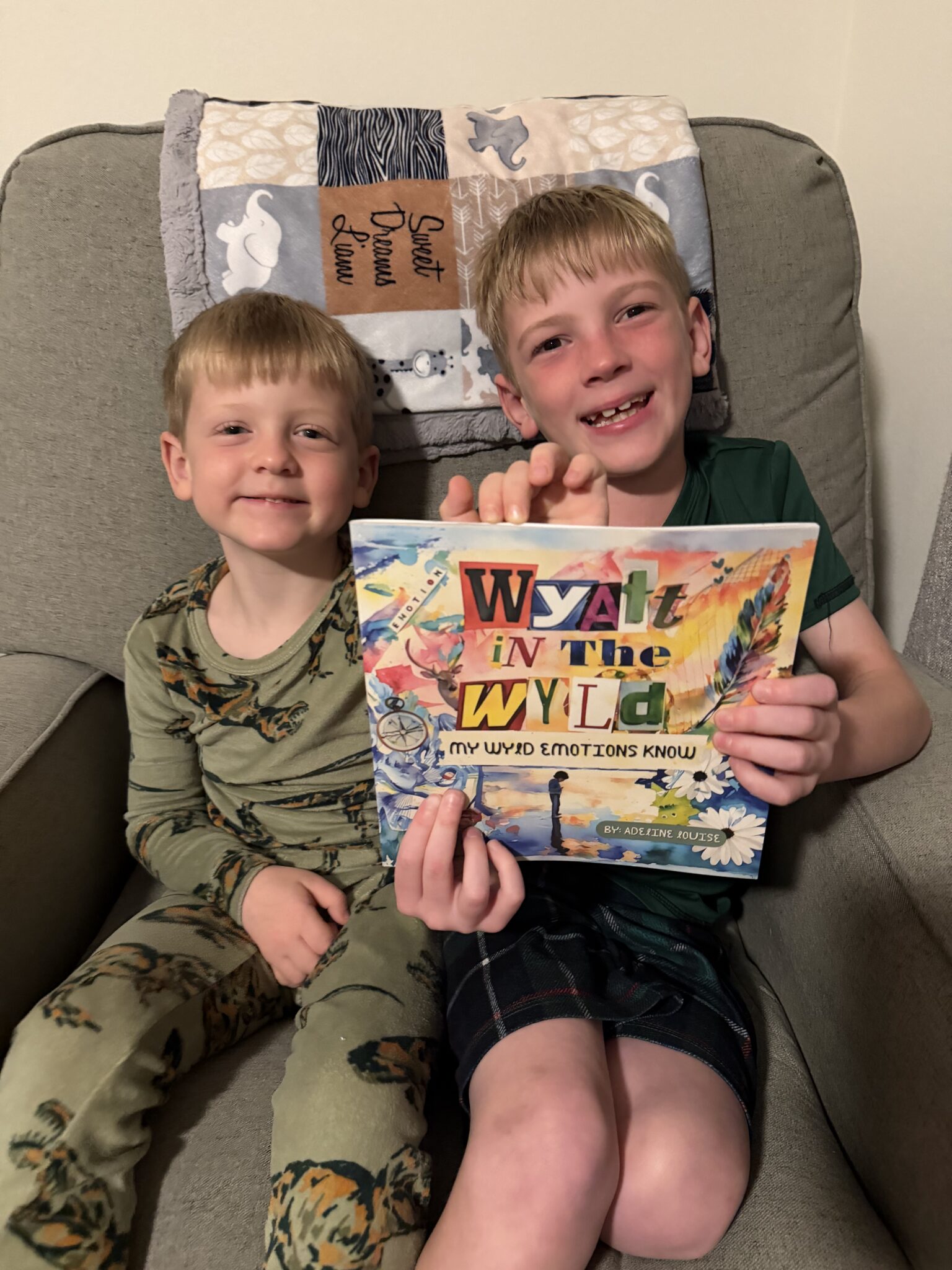 Wyatt in the Wyld: My Wyld Emotions know book being held by two young boys