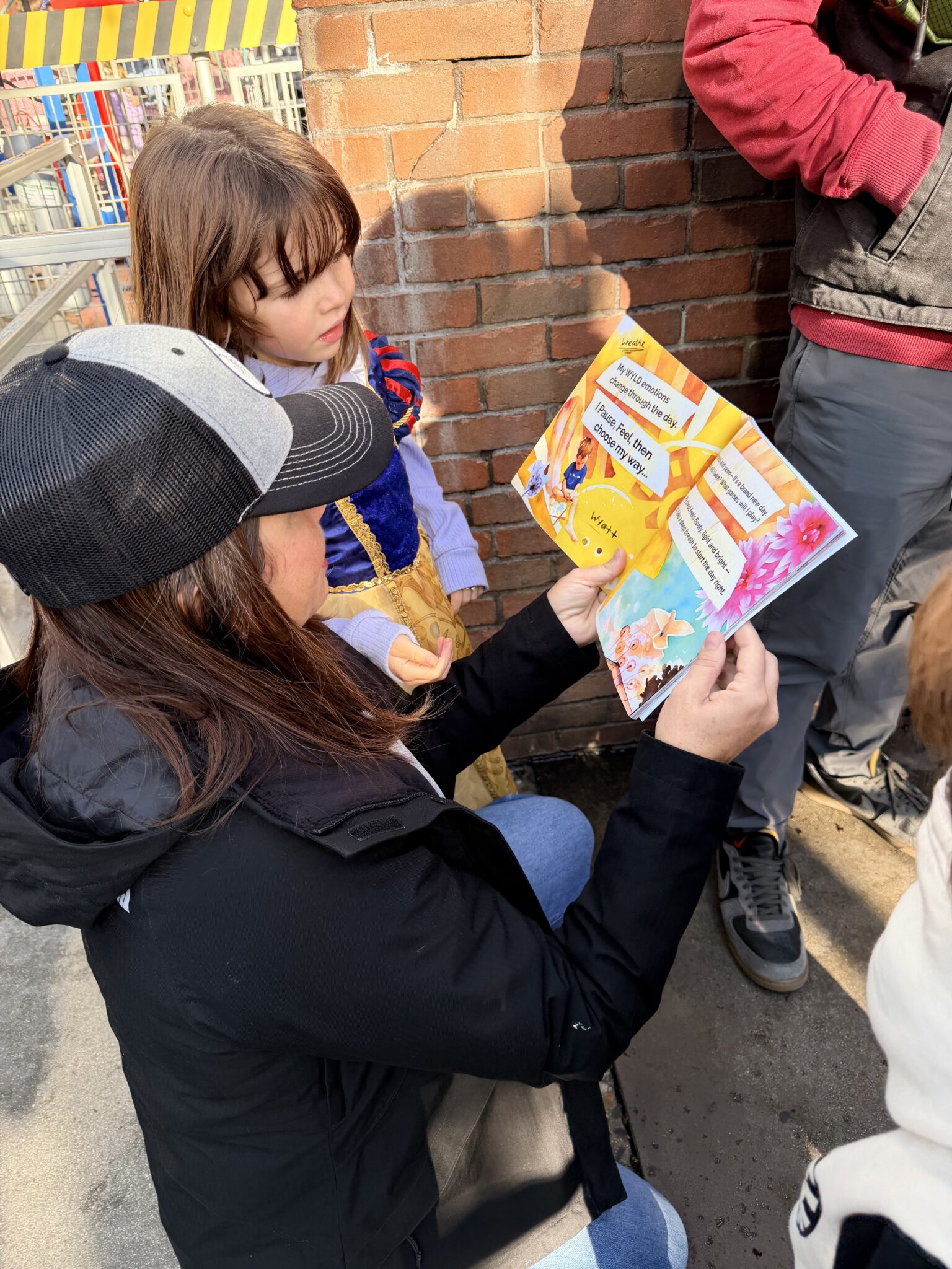 Wyatt in the wyld: My wyld emotions know book being read by mom and daughter at Disneyland